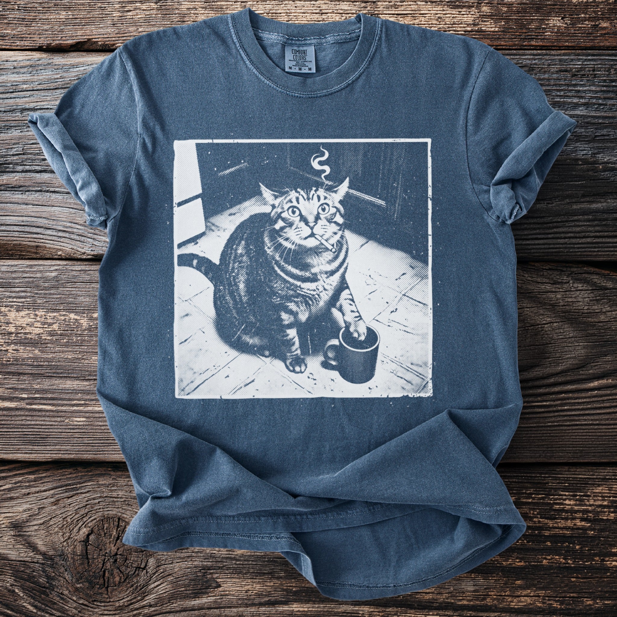 Blue t-shirt with a graphic of a smoking cat holding a coffee cup.