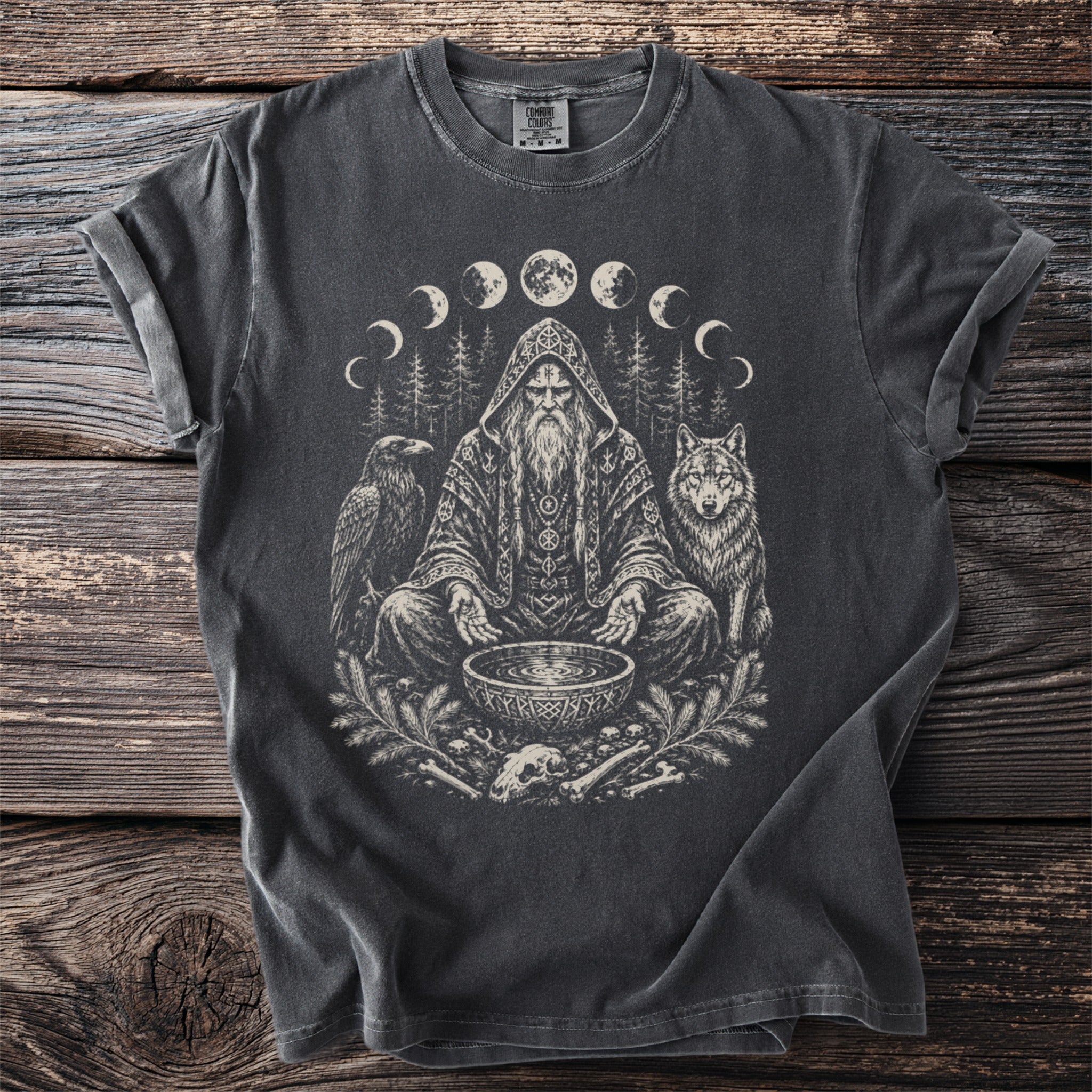 T-shirt features a seated wizard with a raven, wolf, and moon phases graphic.