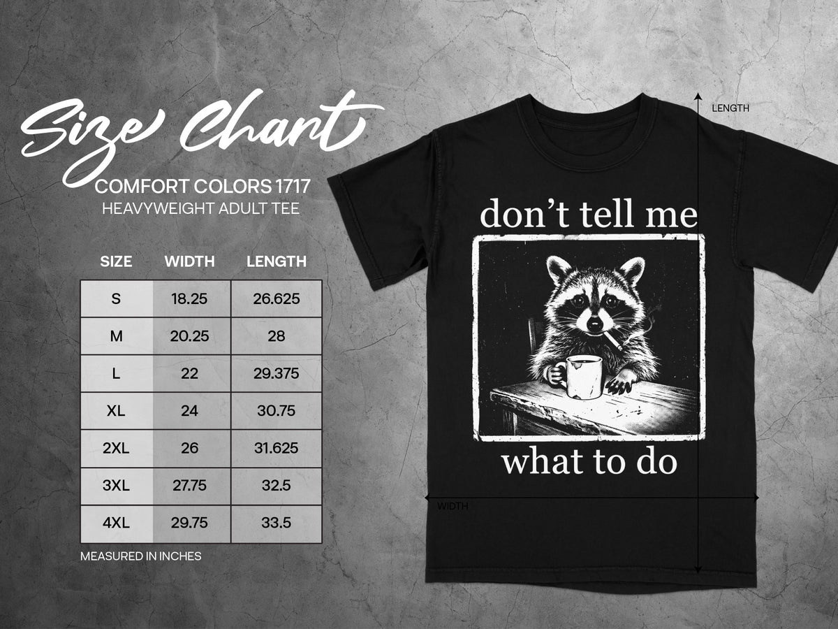 Black t-shirt with raccoon graphic and "don't tell me what to do" text, with size chart.