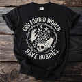 Black t-shirt with white text and graphic featuring hands, skull, and plants.