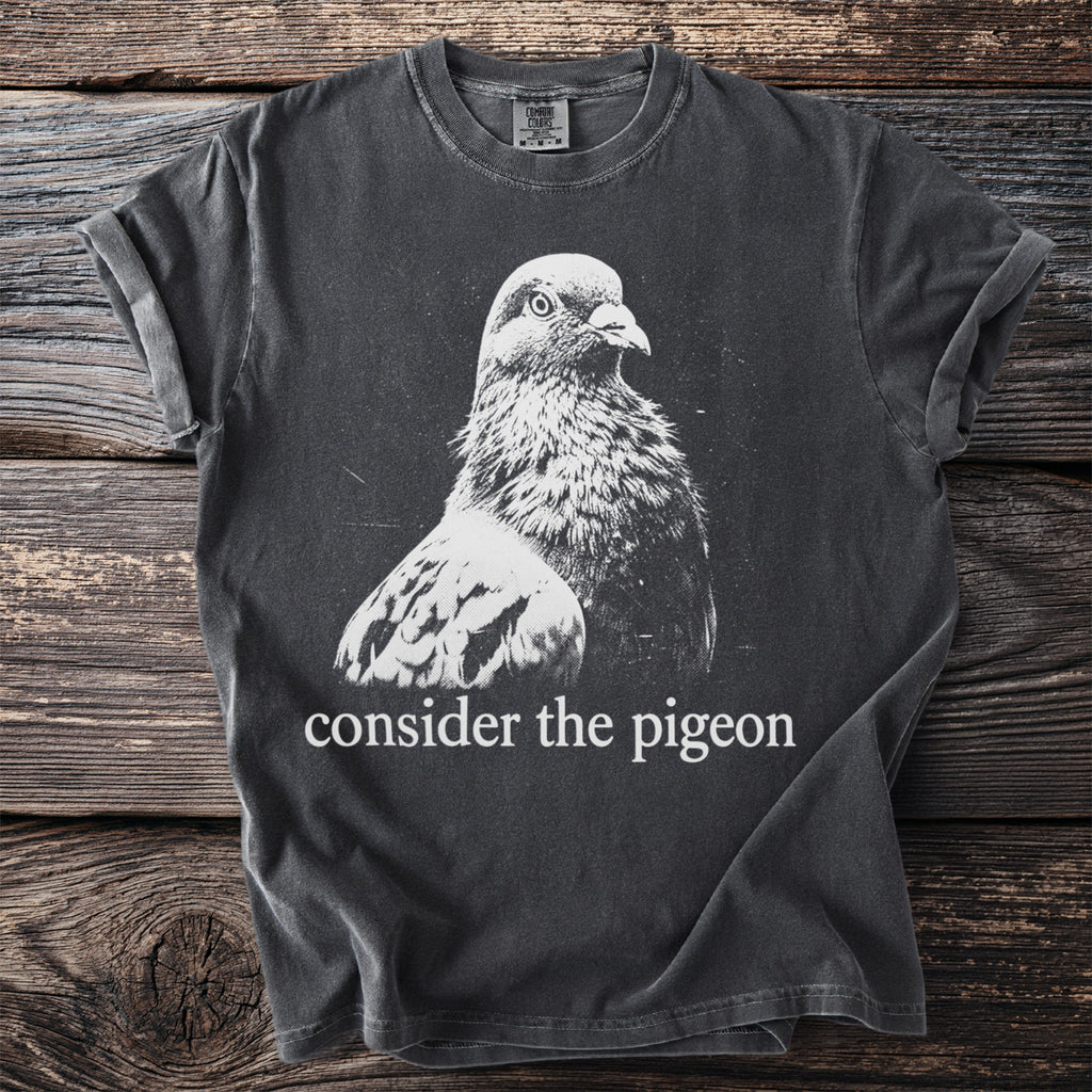 Dark grey t-shirt with white pigeon graphic and "consider the pigeon" text.