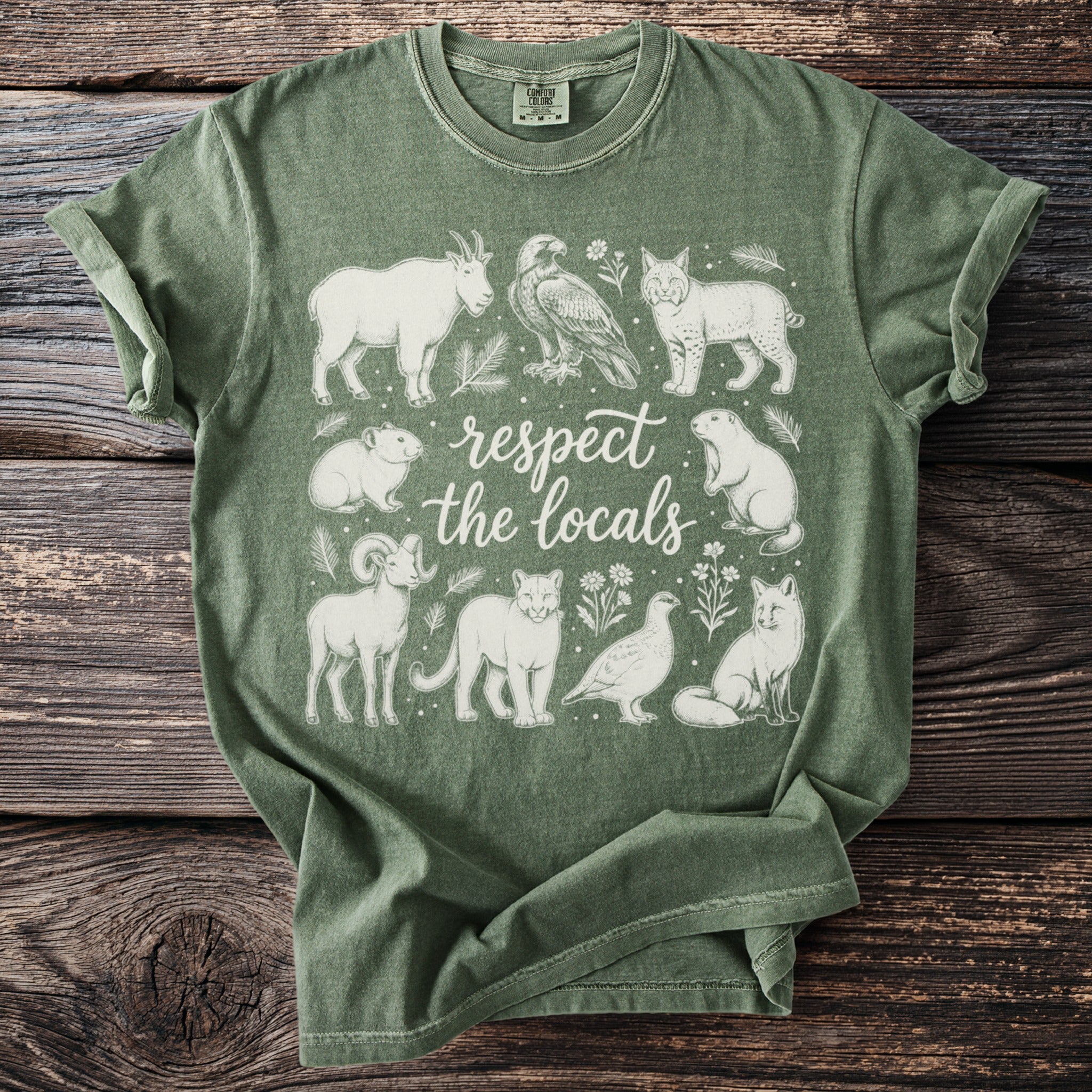 Green t-shirt with white line art of various animals and the text "respect the locals".