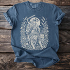 Valkyrie in chariot pulled by cats, sword raised, under full moon.