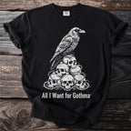 Black t-shirt with a raven perched on a pile of skulls and thorns, text reads "All I Want for Gothma".