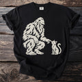 Bigfoot gently pokes a sitting cat with his finger.