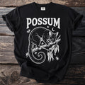 Black t-shirt with white "POSSUM" text and a possum on a branch.