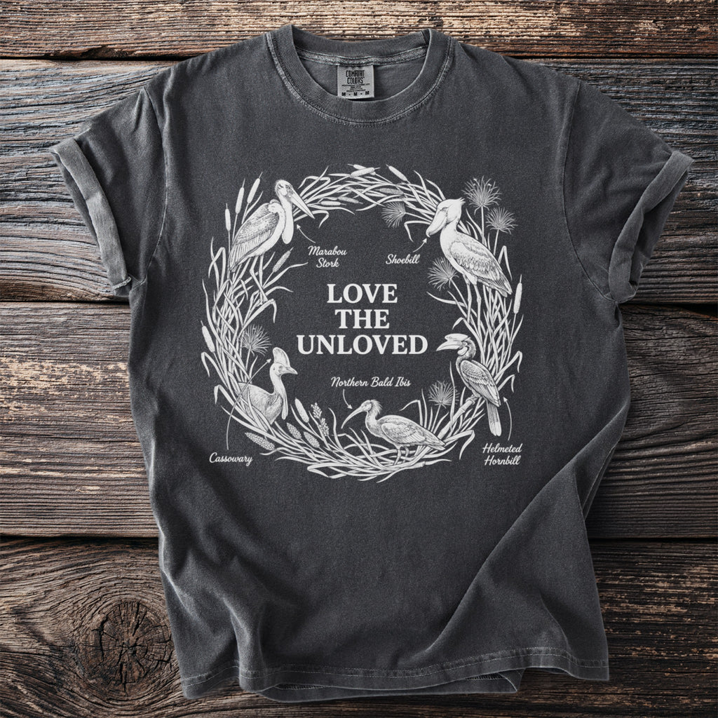 Dark grey t-shirt features "Love The Unloved" text and illustrations of birds.