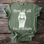 Green t-shirt with goose graphic and text "first of all i'm a delight".