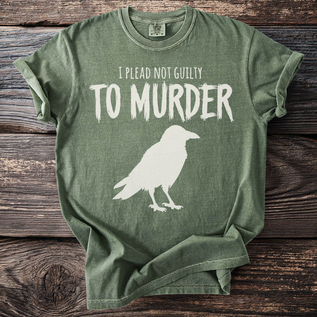 Green t-shirt with white text "I PLEAD NOT GUILTY TO MURDER" and a raven silhouette.