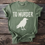 Green t-shirt with white text "I PLEAD NOT GUILTY TO MURDER" and a raven silhouette.