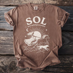 Brown t-shirt with cream graphic of Sol, Norse sun goddess, in chariot pulled by horses and wolves.