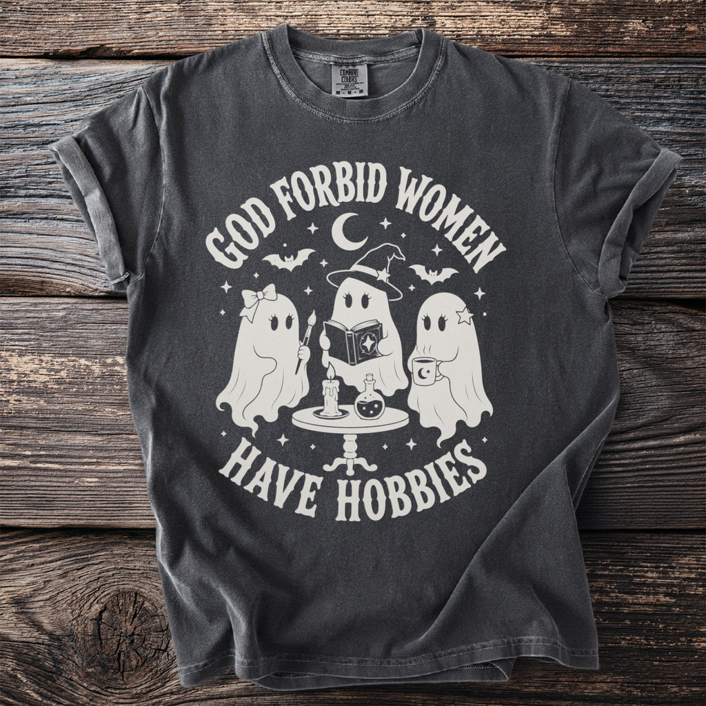 Dark grey t-shirt with graphic "God forbid women have hobbies" and three ghosts.