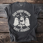Dark grey t-shirt with graphic "God forbid women have hobbies" and three ghosts.