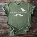 Green t-shirt with white text "scene of the murder" and three crows.
