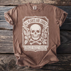 Brown t-shirt with white graphic of skull, bones, and plants; text says "All Plants Are Edible Some Only Once".