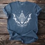 Blue t-shirt with white bat, Christmas tree, and snowflake graphic.