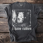 Dark grey t-shirt with a distressed graphic of an opossum and the text "i have rabies".