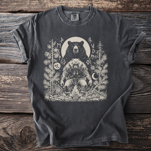 Dark gray t-shirt with a monochrome print of a bear and a man by a campfire.