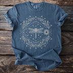 Blue t-shirt with a circular celestial dragonfly, moon, sun, stars, and floral design.