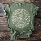 Green t-shirt featuring a circular nature-themed design with a central goddess figure.