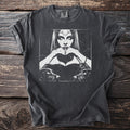 Graphic t-shirt with a woman, dogs, and key design on a dark background.