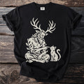 Black t-shirt with a cream print of antlered Cernunnos booping a cat.