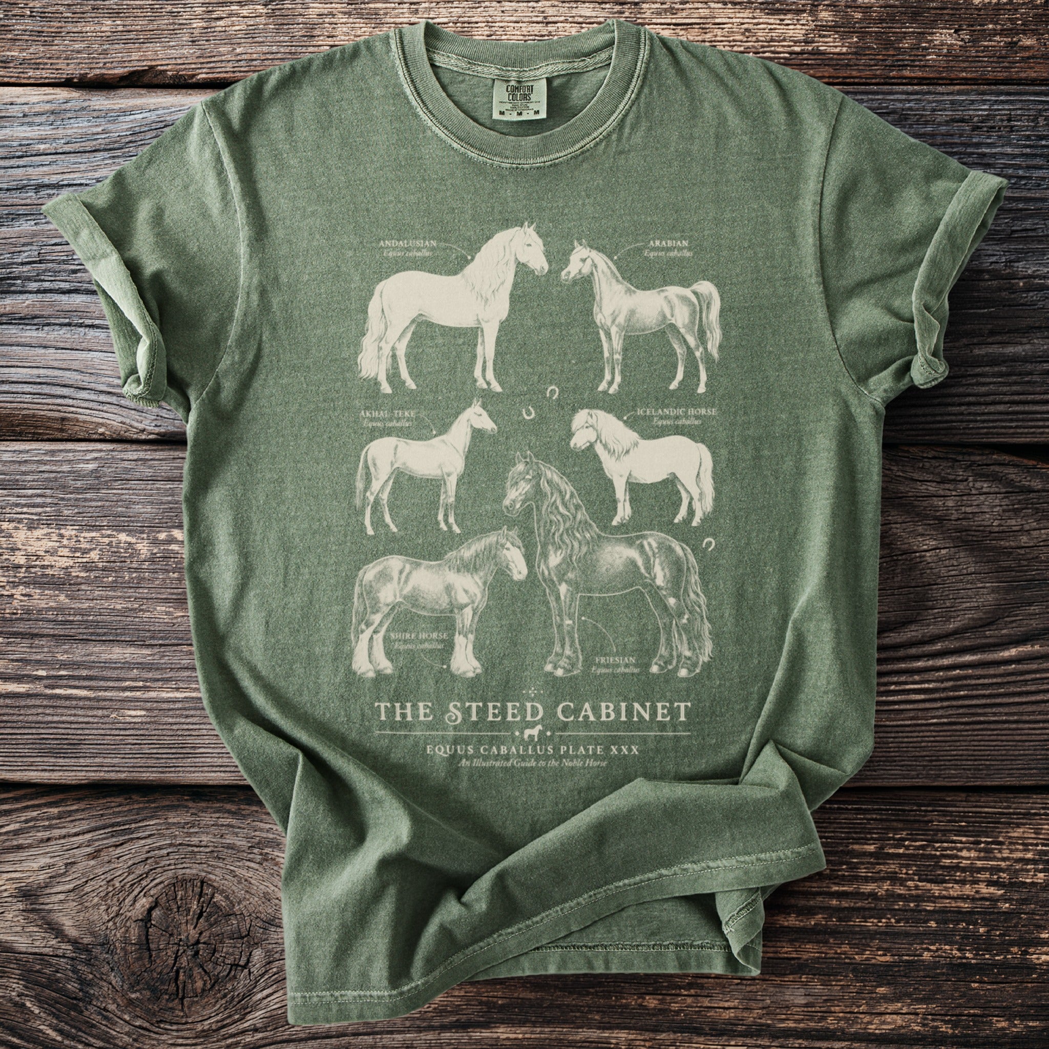 Green t-shirt with illustrations of six horse breeds and text "The Steed Cabinet".
