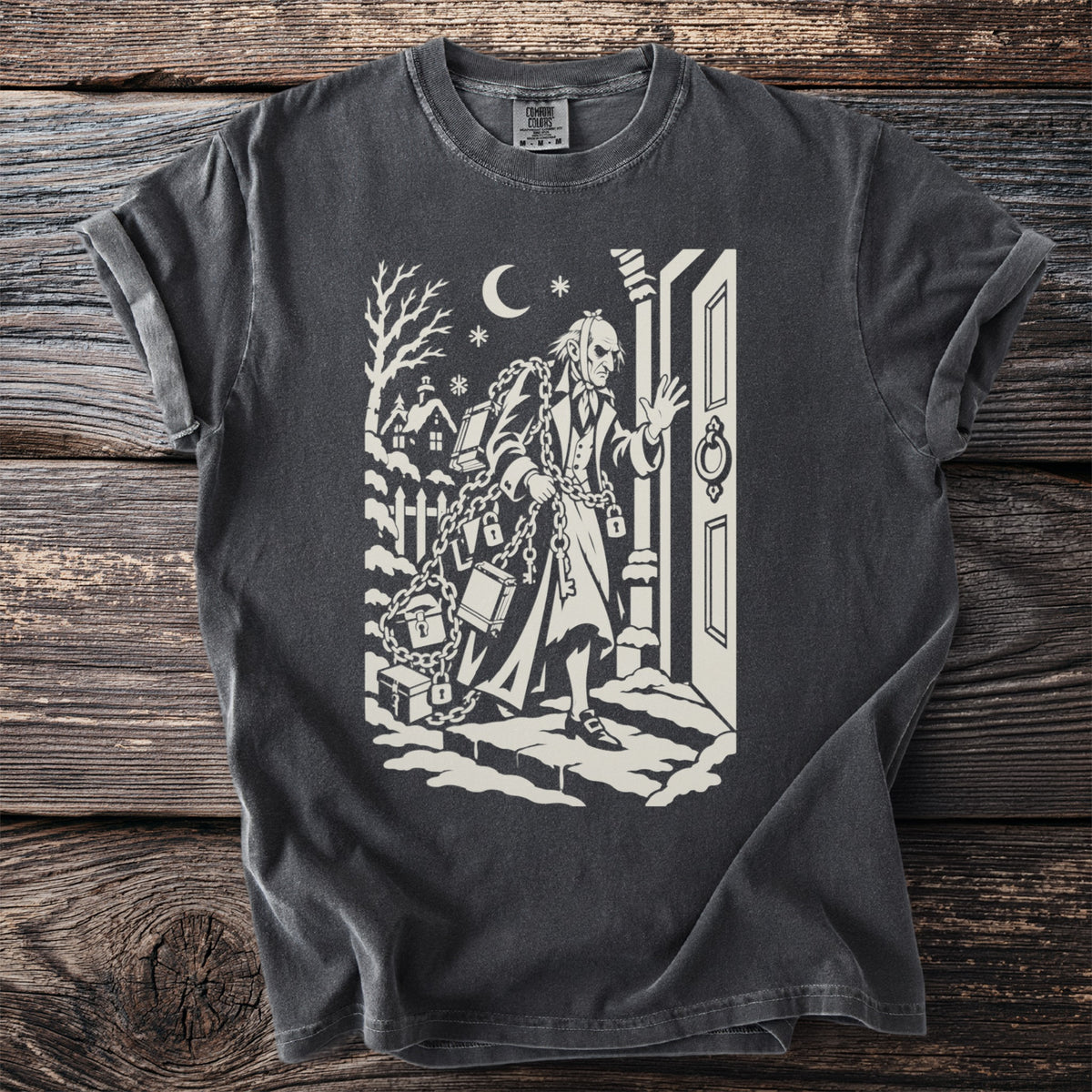 Pepper gray t-shirt with a cream folk-cut print: Marley's ghost stands at a door in the snow, wrapped in chains, padlocks and cash boxes.