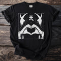 Black t-shirt with a black and white graphic of a crowned figure making a heart with hands.