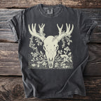 Charcoal t-shirt with a cream-colored graphic of a deer skull with antlers and botanical elements.