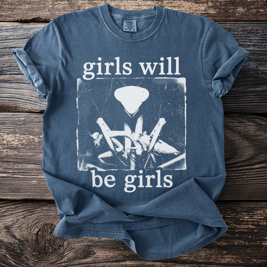Blue t-shirt with "girls will be girls"text and a graphic of a praying mantis.