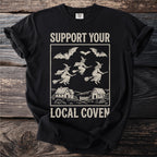 Black t-shirt with "Support Your Local Coven" design featuring witches and bats.