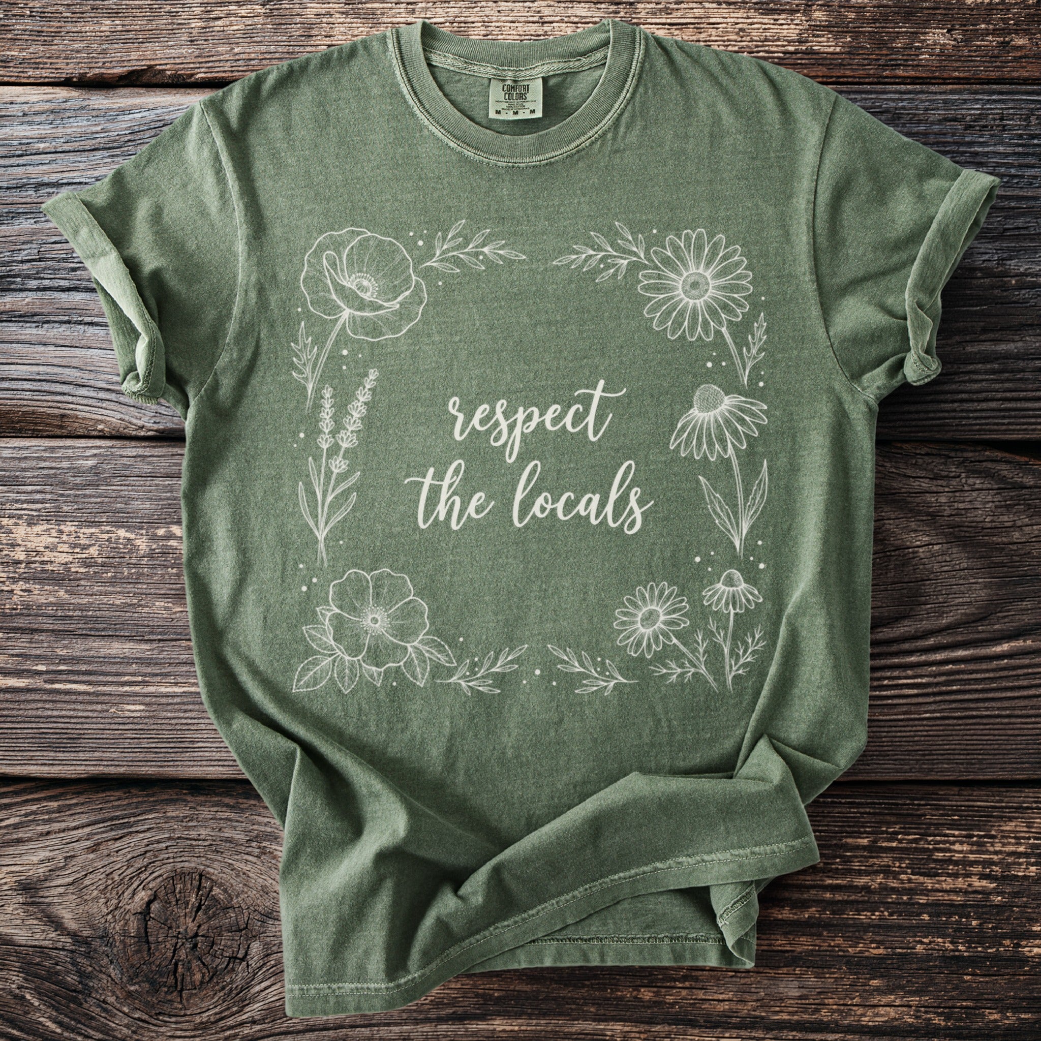 Olive green t-shirt with white floral border and "respect the locals" text.