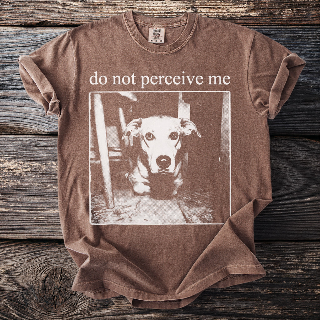 Brown t-shirt with "do not perceive me" text and a close-up of a dog's face.