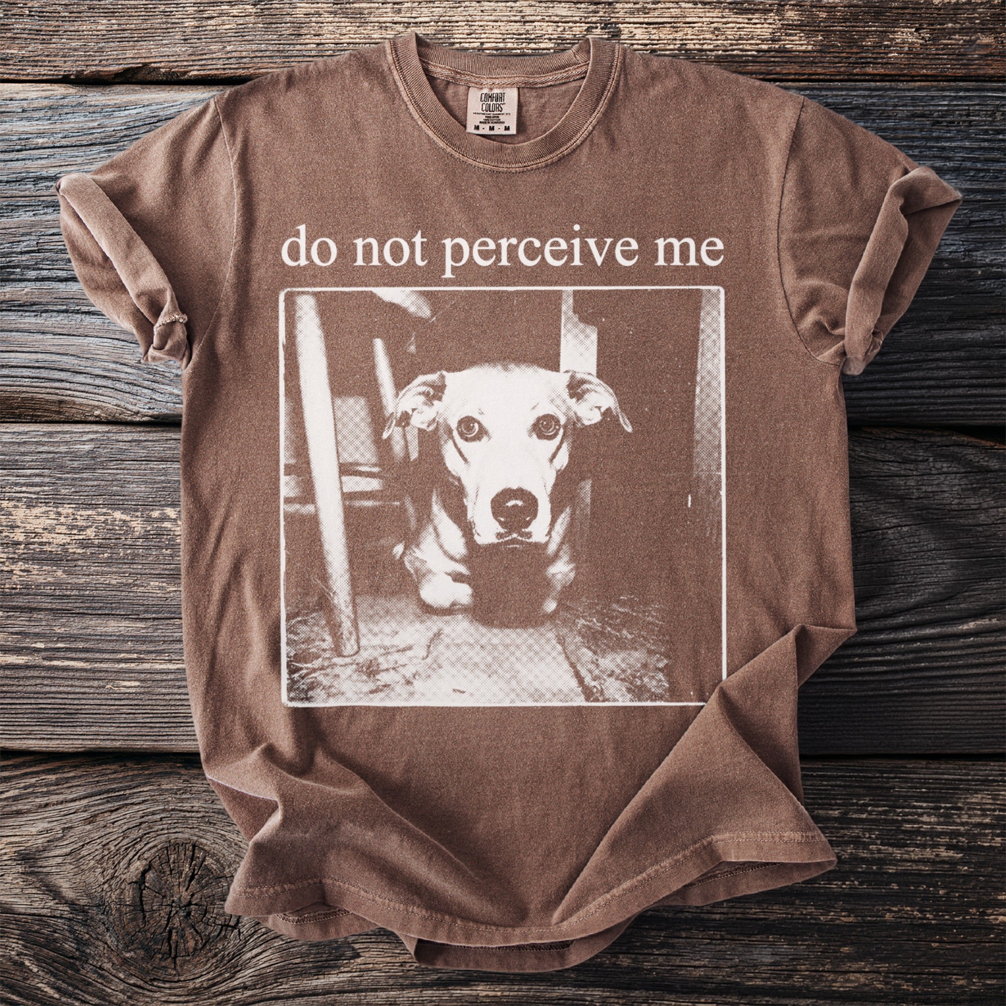 Brown t-shirt with "do not perceive me" text and a close-up of a dog's face.