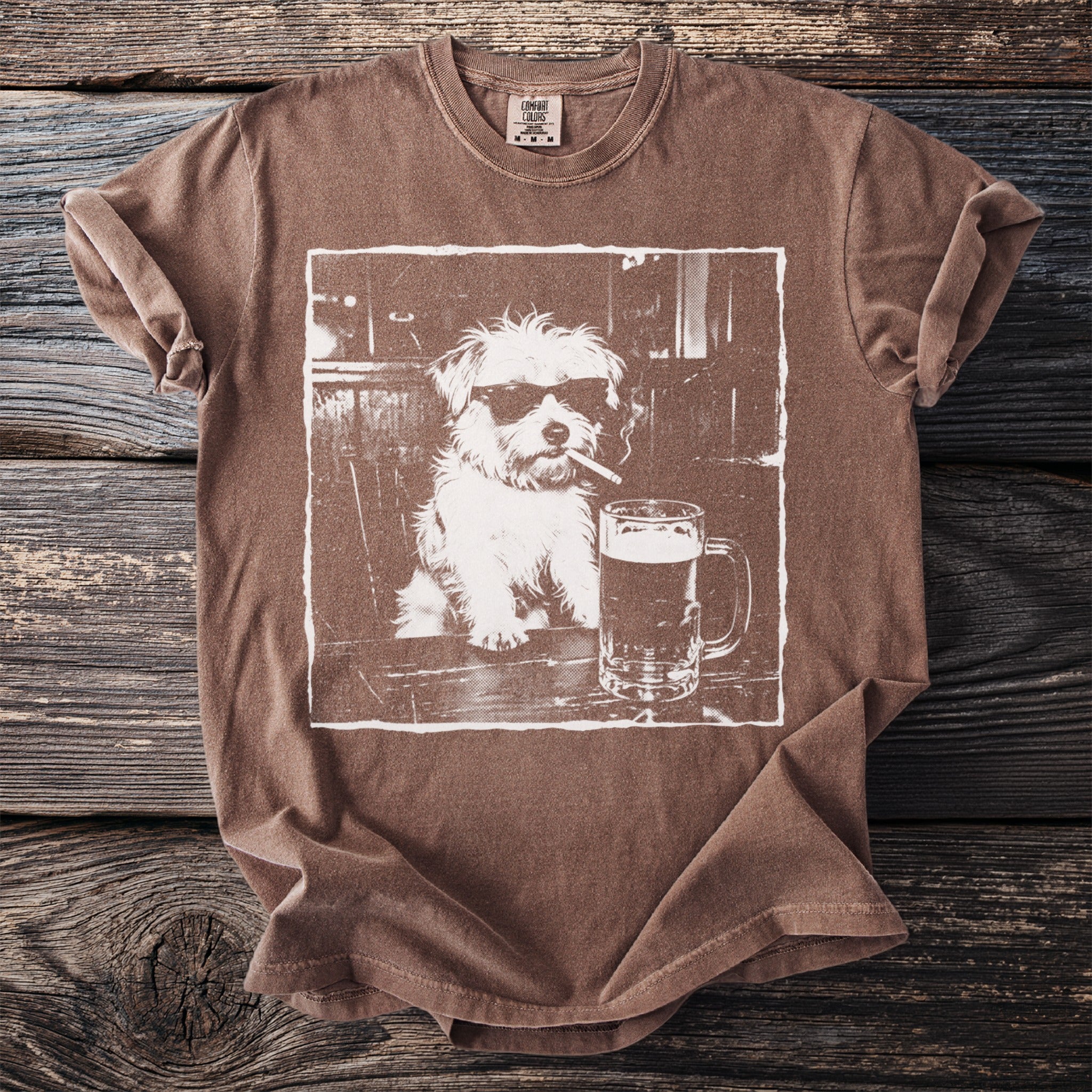 Brown t-shirt with a white graphic of a dog wearing sunglasses and smoking a cigarette next to a beer.