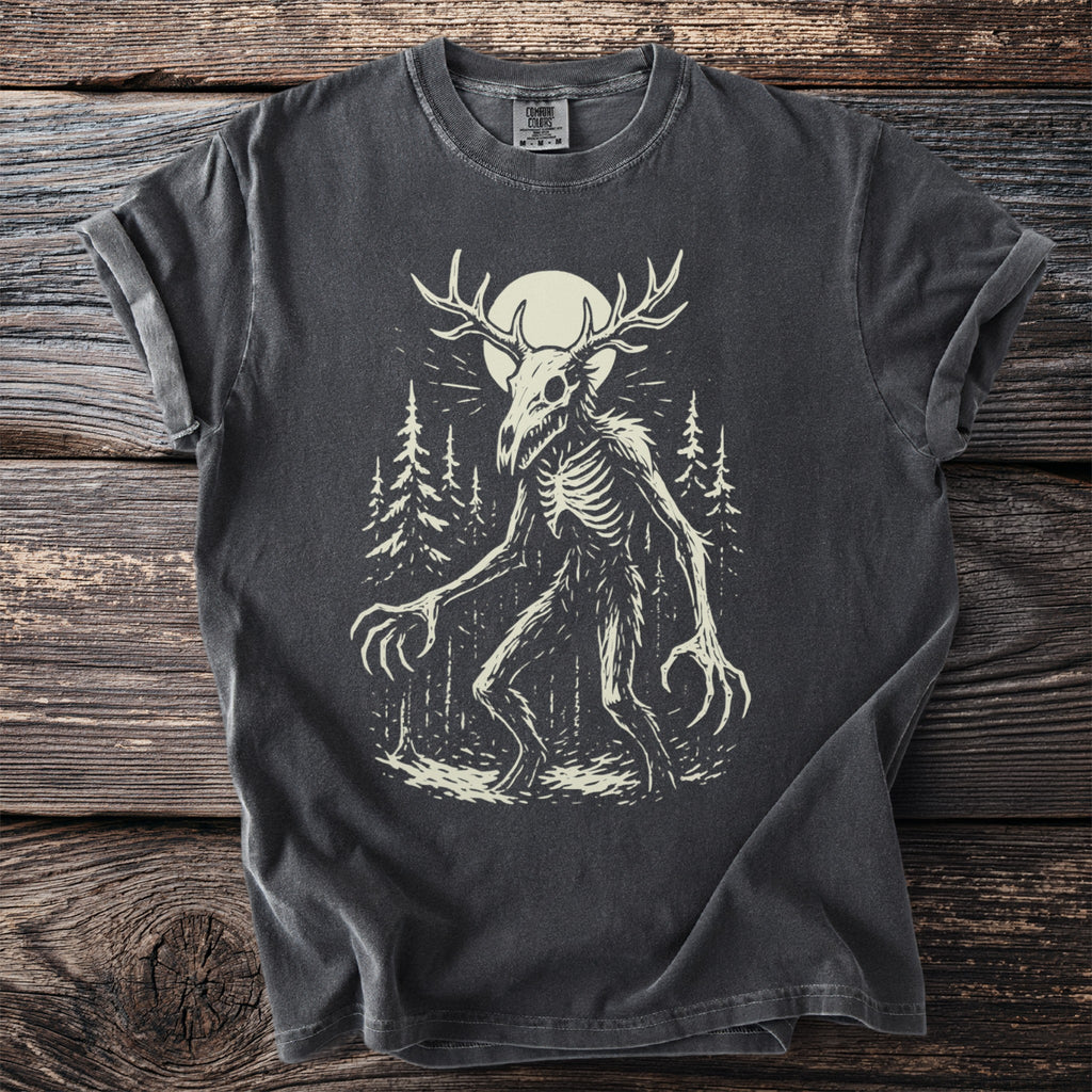 Dark grey t-shirt with a skeletal creature with antlers and long claws in a forest.