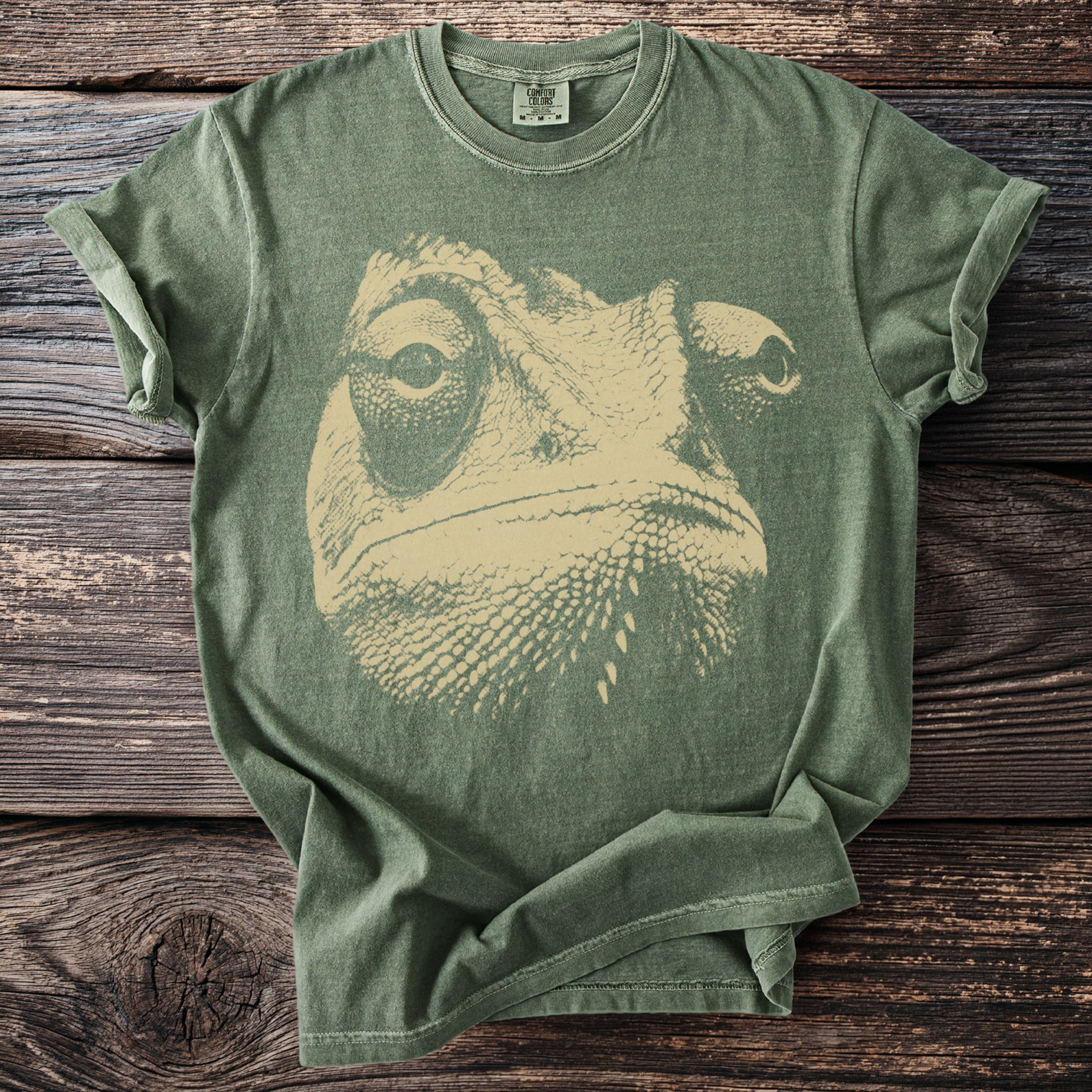 Green t-shirt with a beige chameleon face graphic and Comfort Colors label