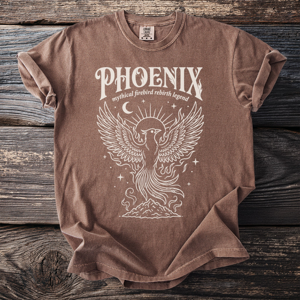 Brown t-shirt with white phoenix graphic and text "PHOENIX mythical firebird rebirth legend".