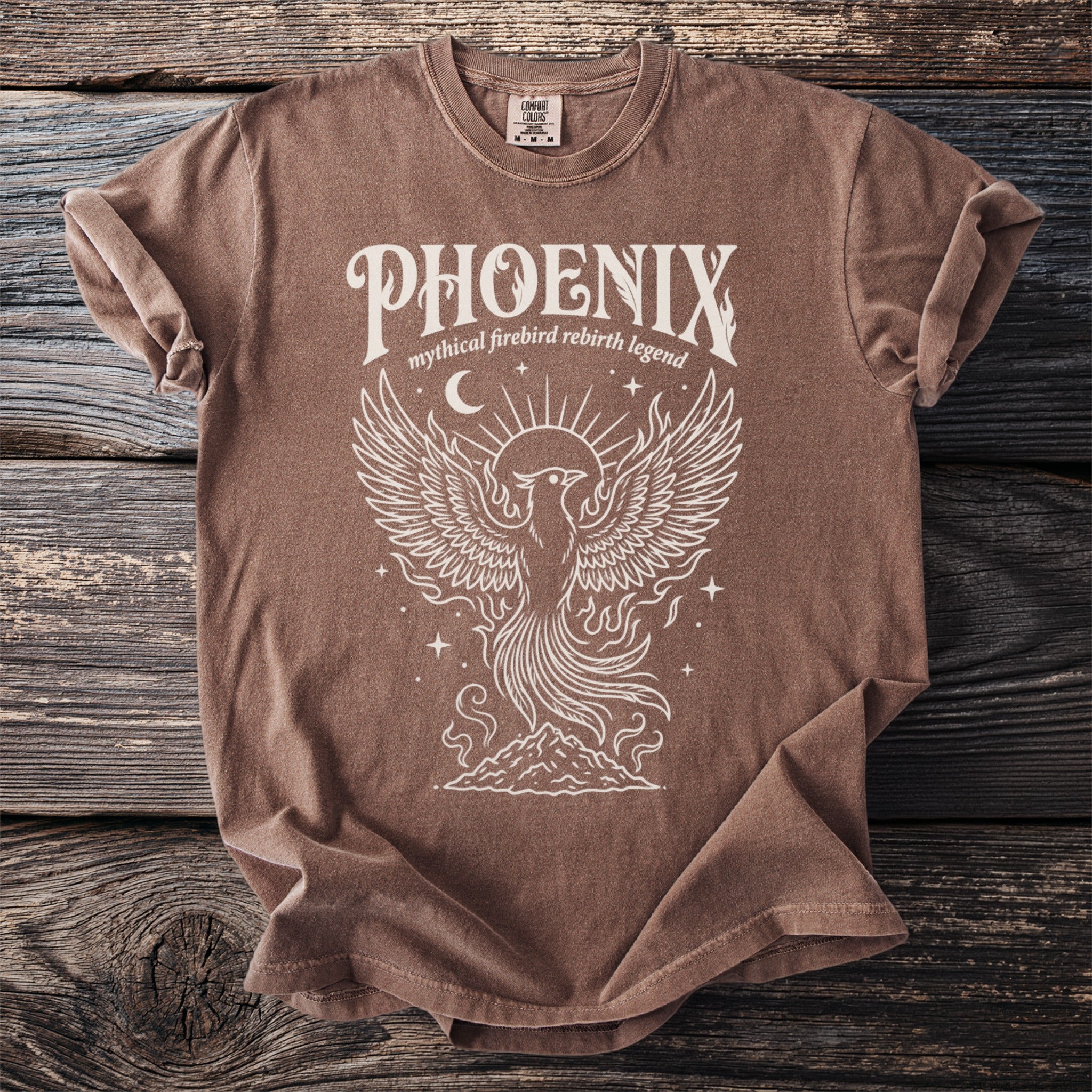 Brown t-shirt with white phoenix graphic and text "PHOENIX mythical firebird rebirth legend".