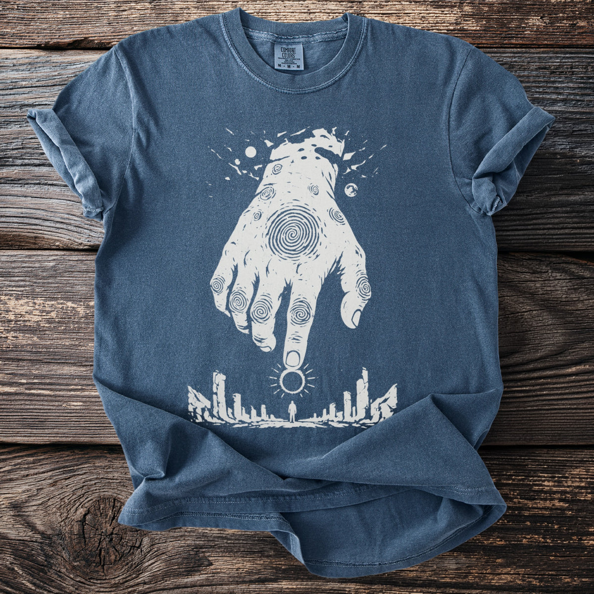 Blue t-shirt with white abstract hand graphic and standing figure.
