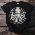 Black t-shirt featuring a white circular design of an octopus with starry accents.