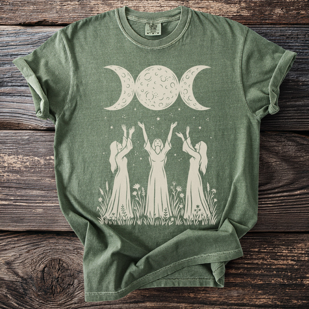 Green t-shirt with a triple moon and three women with raised arms graphic.