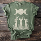 Green t-shirt with a triple moon and three women with raised arms graphic.
