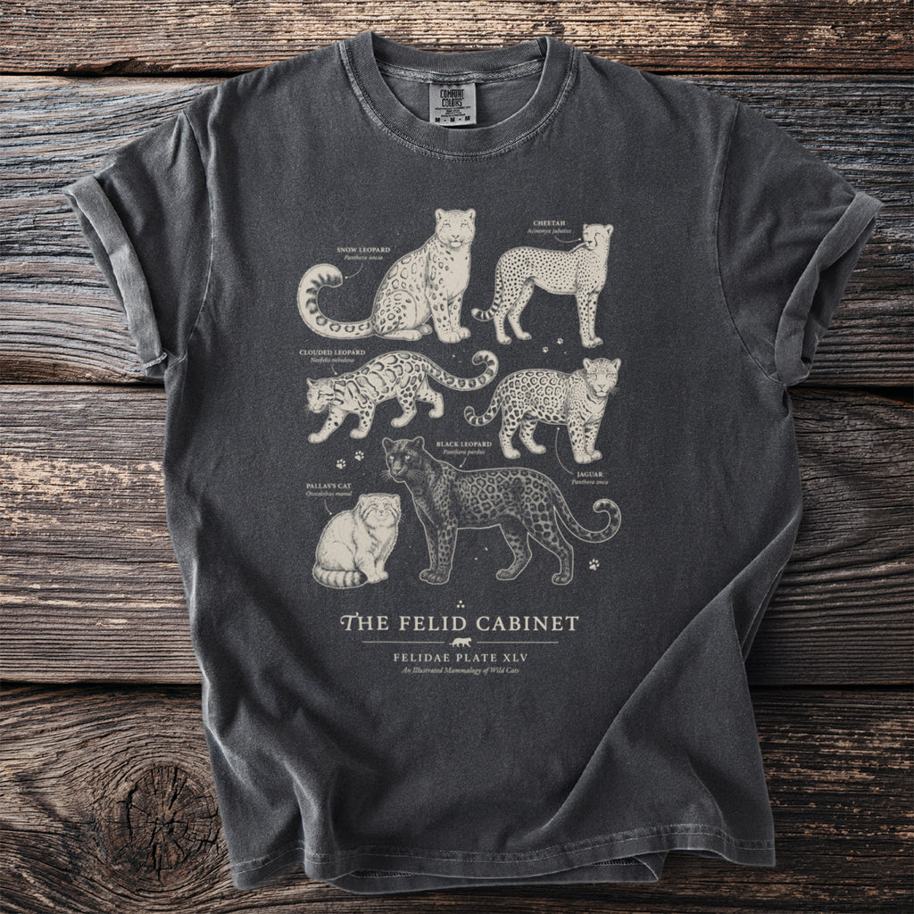 Dark grey t-shirt print featuring illustrations of various wild cats from "The Felid Cabinet."