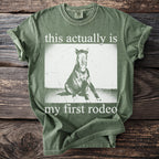 Green t-shirt with "this actually is my first rodeo" text and a horse graphic.