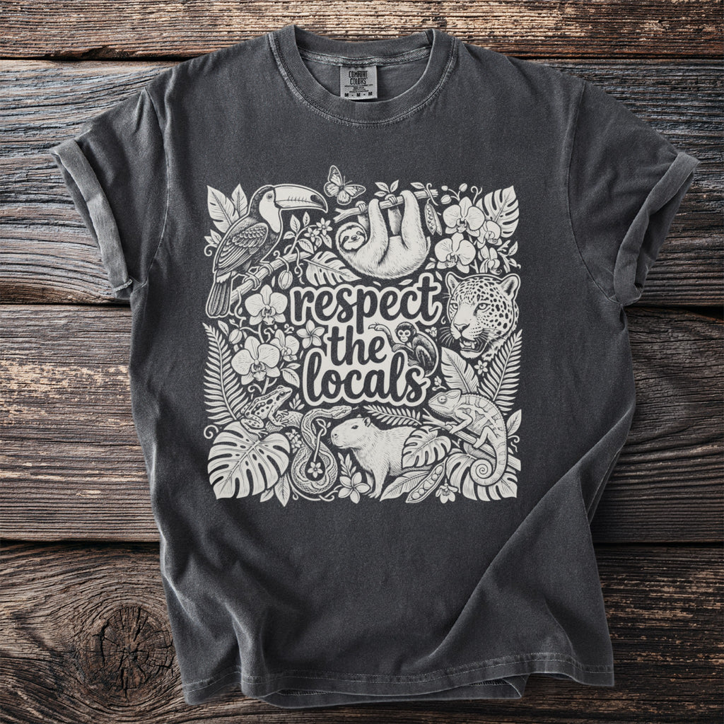 Dark grey t-shirt with a white artistic design of rainforest animals and plants.