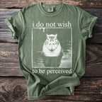 Green t-shirt with a capybara graphic and "i do not wish to be perceived" text.
