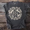 Dark t-shirt with cream-colored circular design of a fox, rabbits, and foliage.
