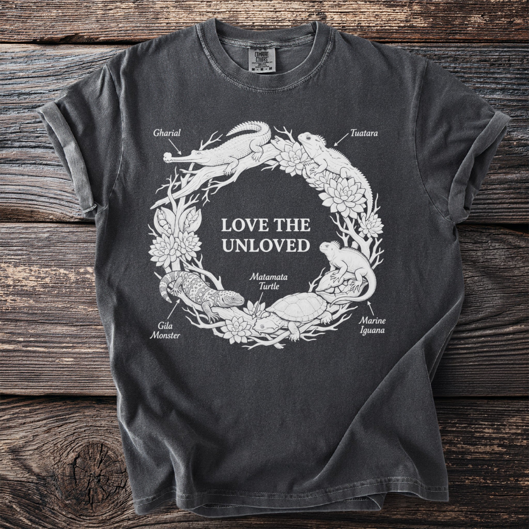 T-shirt graphic with "Love the Unloved" text and labeled reptiles in a circular design.